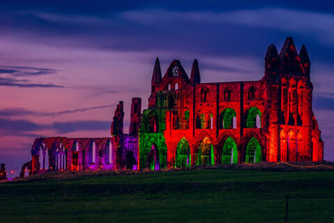 Whitby Abbey lit up at night
